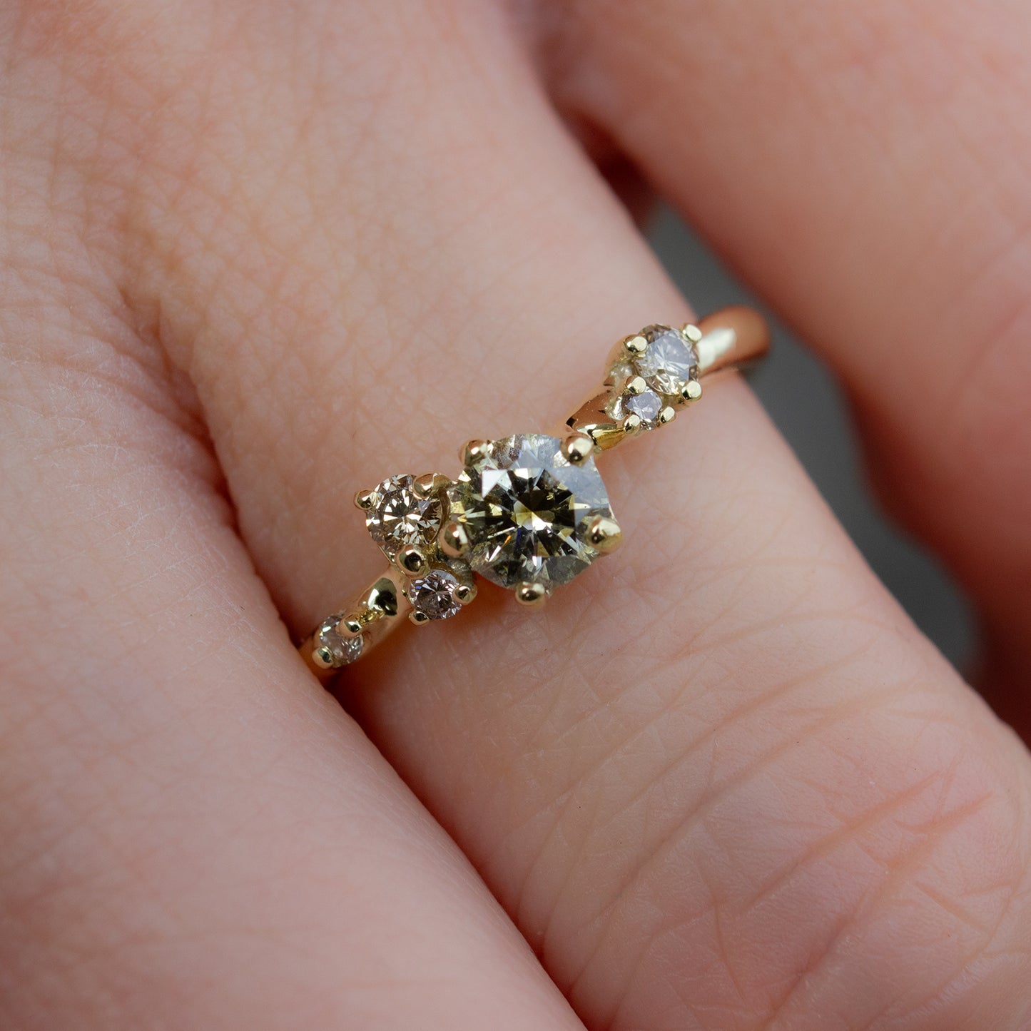 Beautiful and delicate alternative engagement ring featuring champagne diamonds gently scattered along the band. Resembling first flower buds this ring was inspired by.