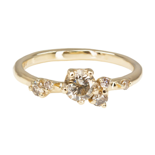 Beautiful and delicate alternative engagement ring featuring champagne diamonds gently scattered along the band. Resembling first flower buds this ring was inspired by.