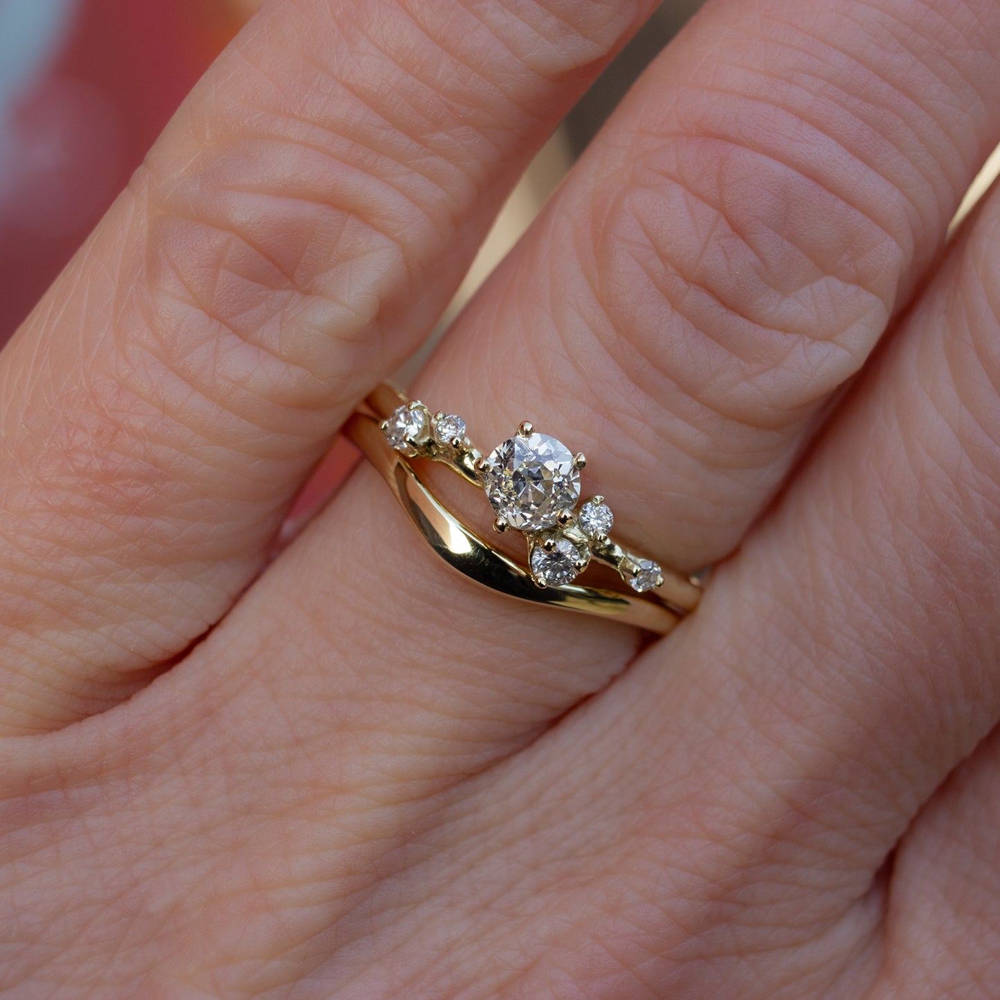 Delicately shaped gold wedding band. Design to gently hug your engagement ring. Shown with our old cut diamonds alternative engagement ring.