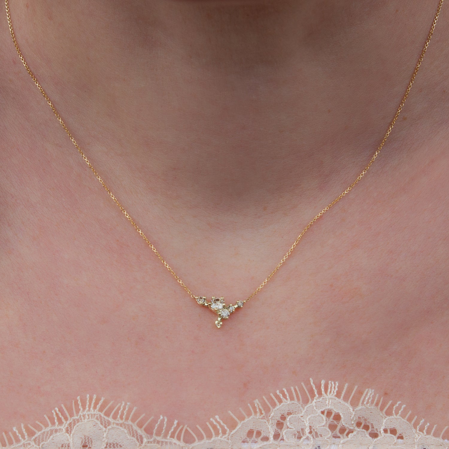 Delicate cluster necklace featuring champagne diamonds and inspired by first blossoms.