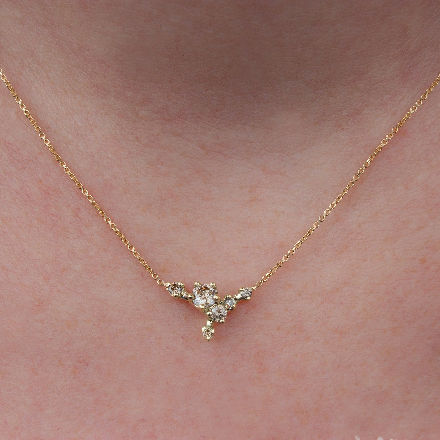 Delicate cluster necklace featuring champagne diamonds and inspired by first blossoms.