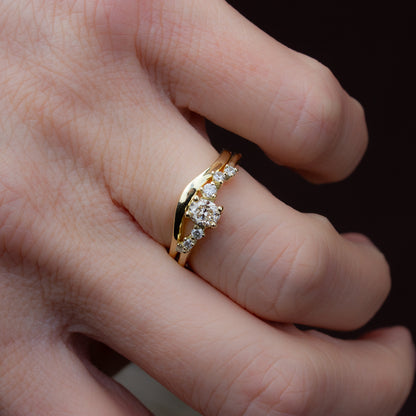 Alternative engagement ring featuring champagne and white diamonds and inspired by flow of natural forms. Coupled with a curved gold wedding band.