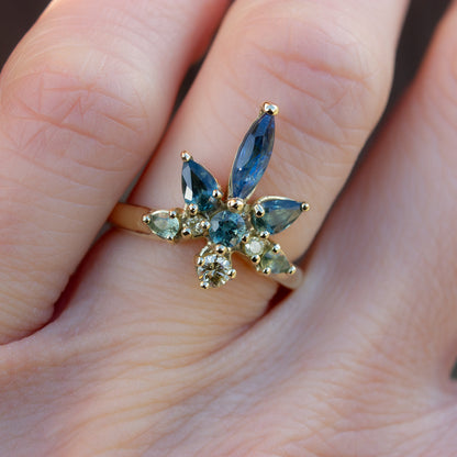 Beautiful coctail ring inspired by water lilies. Featuring blue, teal and green sapphires and yellow diamonds, arranged in the shaped of a flower.