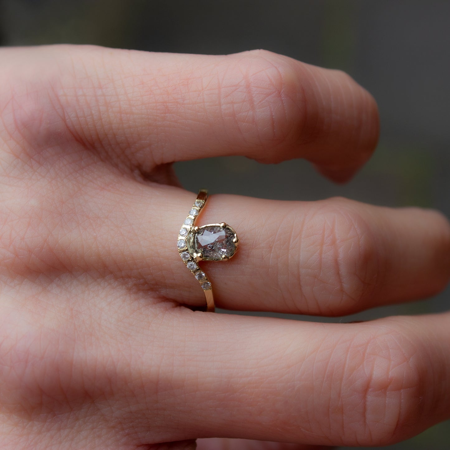 Delicate curved ring in gold featuring cushion rose cut grey diamond and smaller grey diamonds. Irena Chmura Jewellery