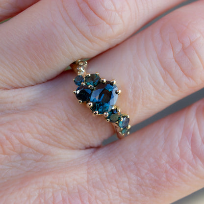 Beautiful, organically shaped alternative engagement or coctail ring. Ring features teal sapphires and champagne diamonds, fluidly scattered along the band.