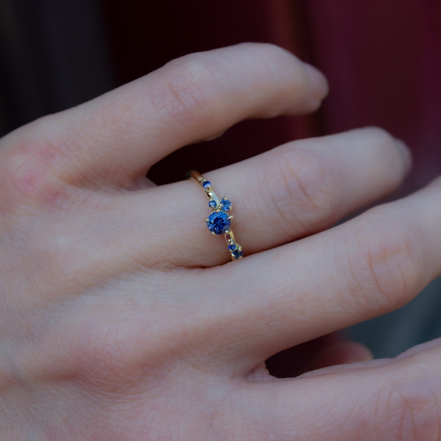 Beautful, delicate ring glimmering with cornflower blue sapphires gently scattered along the band.