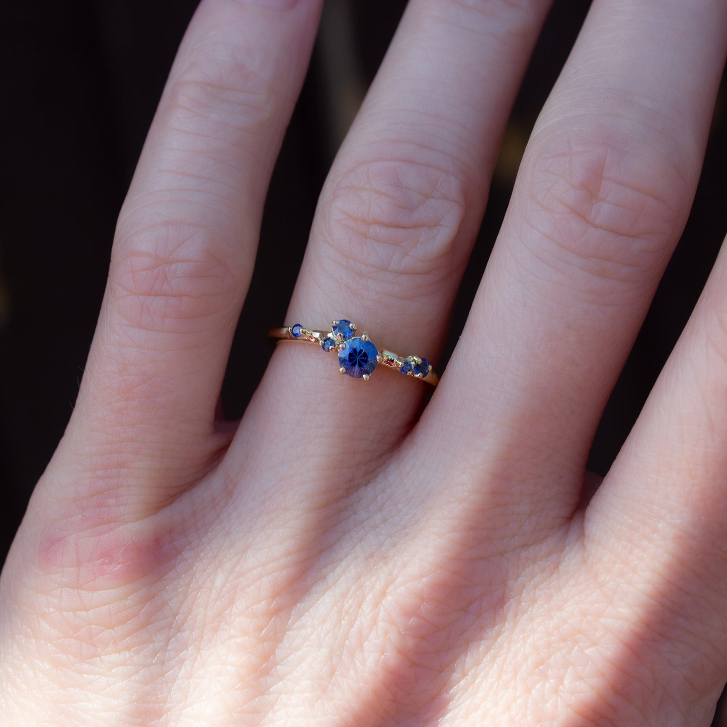 Beautful, delicate ring glimmering with cornflower blue sapphires gently scattered along the band.