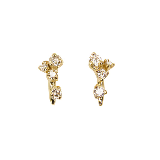Gold earrings with diamond-like stones on a white background