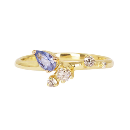 Gold ring with a purple gemstone and two diamonds on a white background