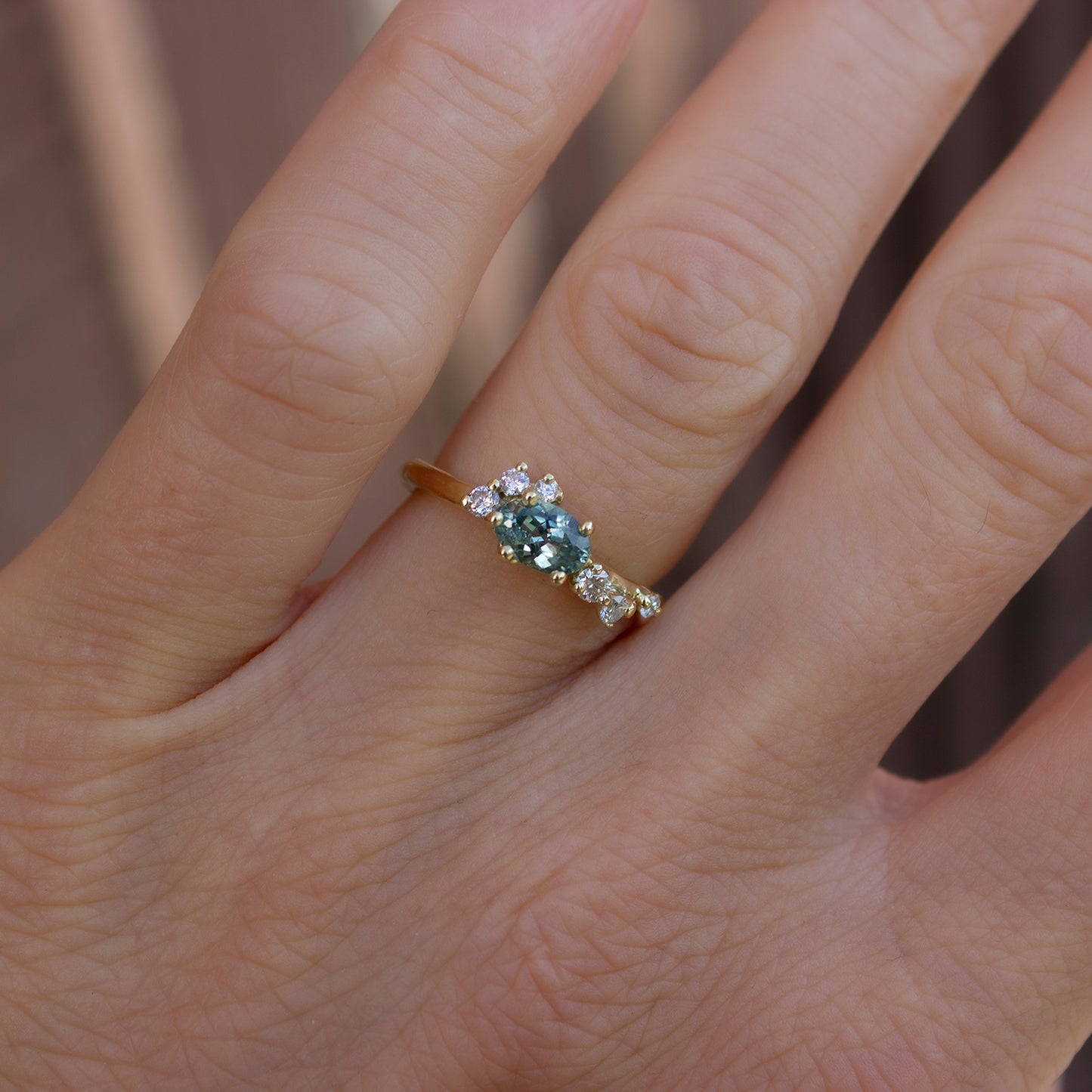 Delicate and beautiful ring featuring teal sapphire and white diamonds. Perfect option as an alternative engagement ring for a modern bride.